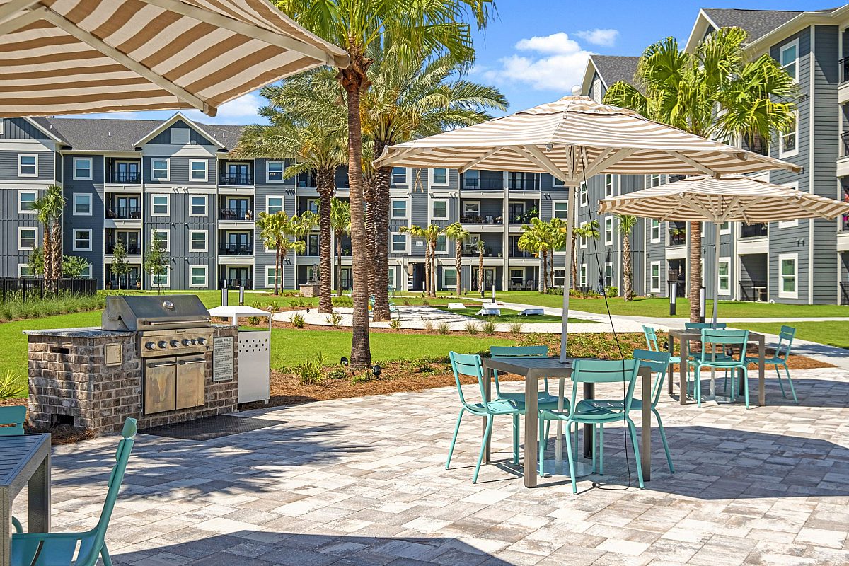 grilling station with outdoor tables and chairs