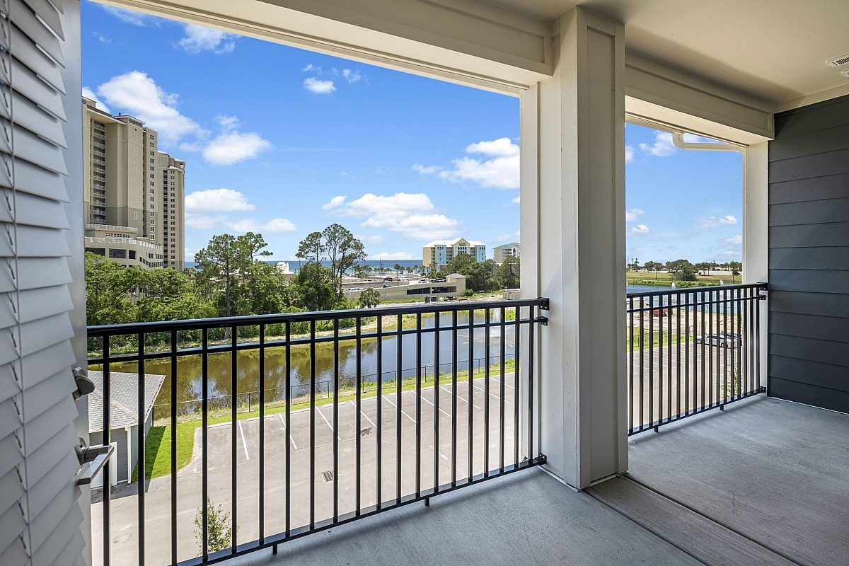 balcony of an apartment complex with beach and sky view