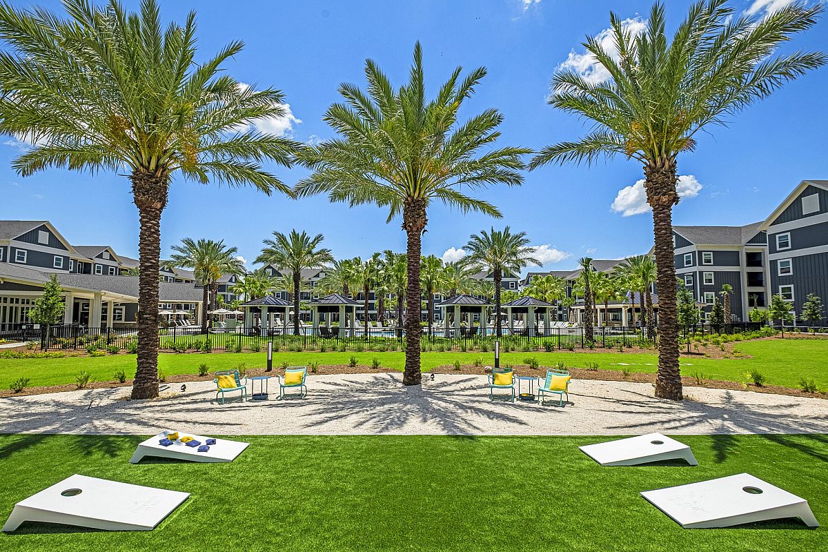 kids playground with chairs, tables, and cornhole toys