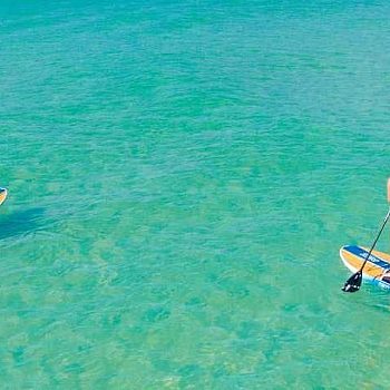 couple paddling in the beach